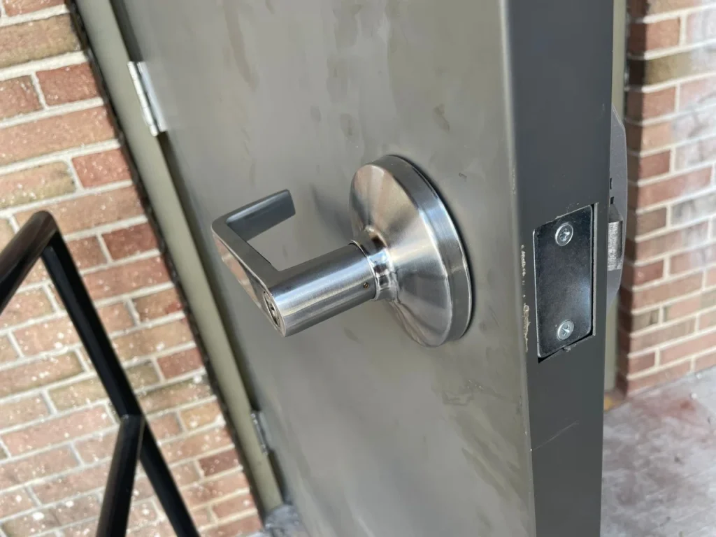 Stainless steel lever lock on a metal door with the latch bolt exposed in philadelphia